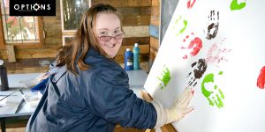 happy lady doing handprint artwork
