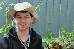 Man in a hat standing in Edible Garden