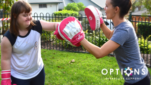 woman boxing with fitness trainer